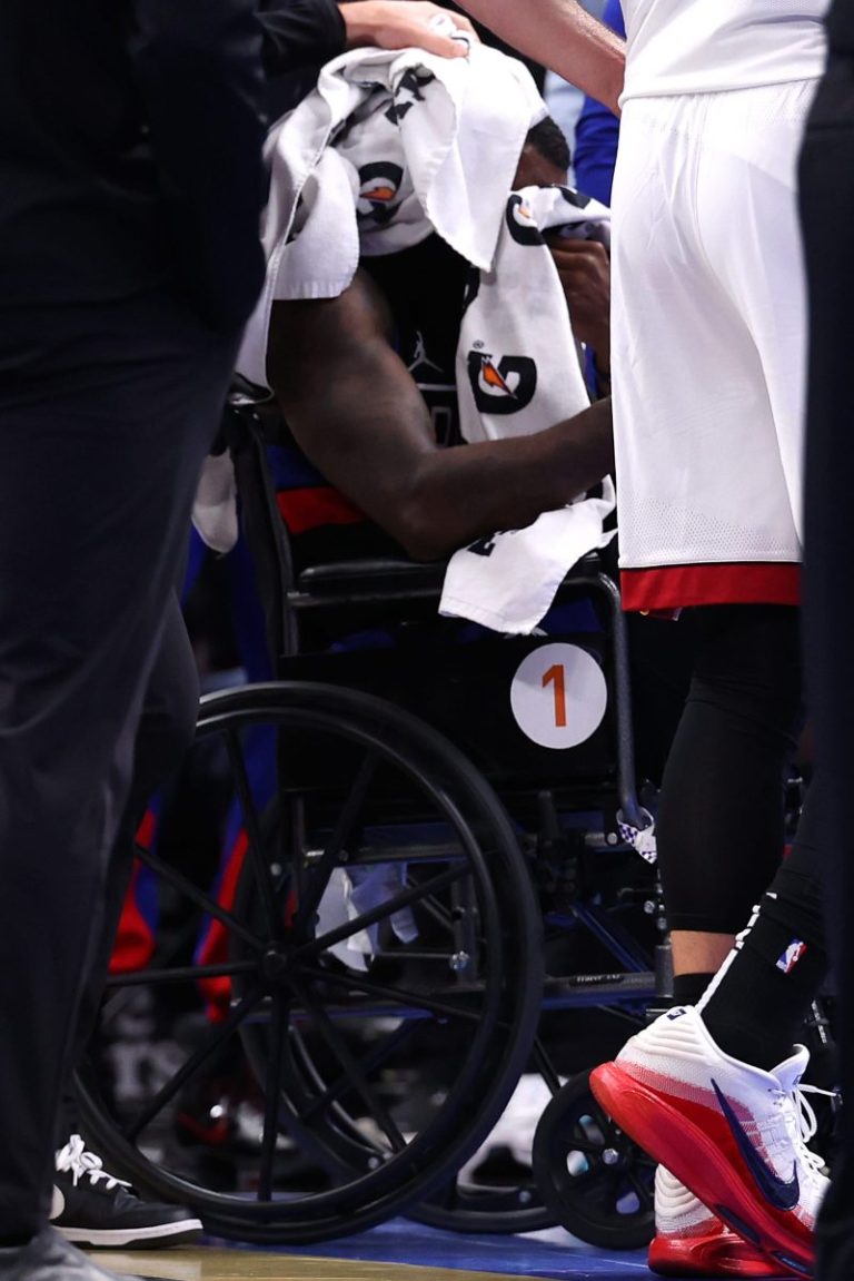 Pistons guard exits in wheelchair after hitting head on court