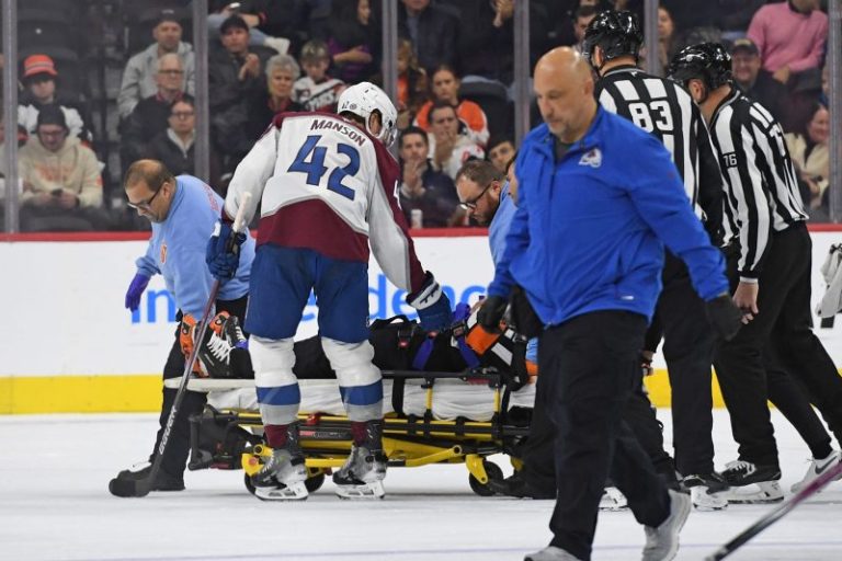 NHL referee leaves ice on stretcher after collision